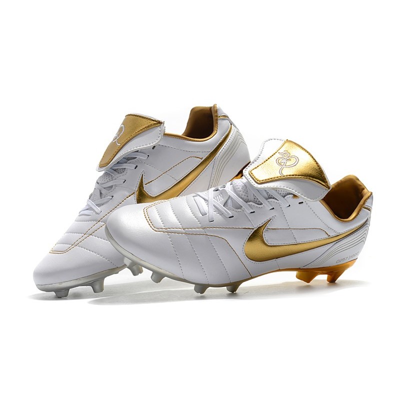 white and gold nike boots